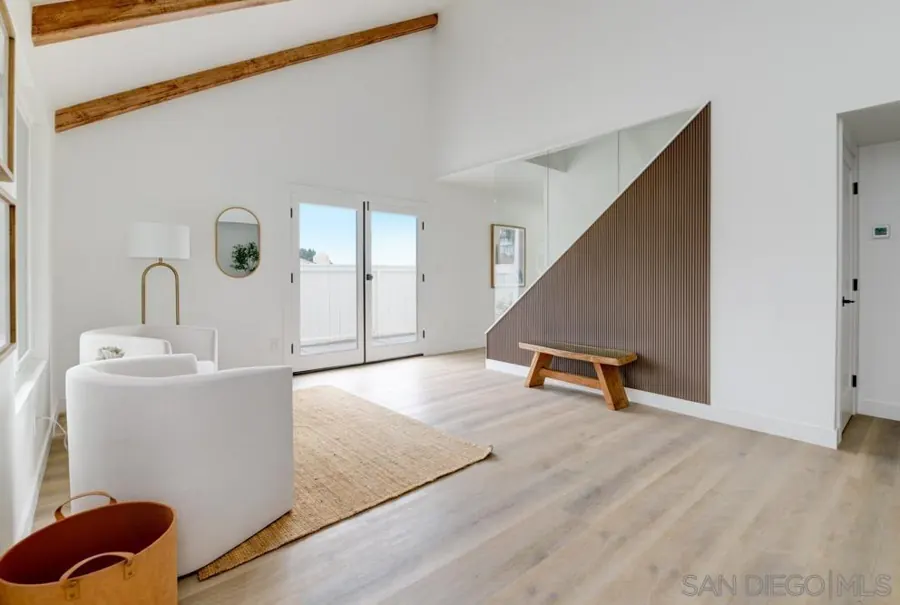 Entry room with slatted wood stair wall