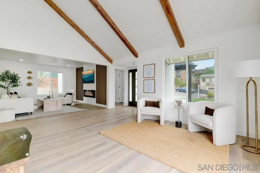 Open living area with exposed wood beams