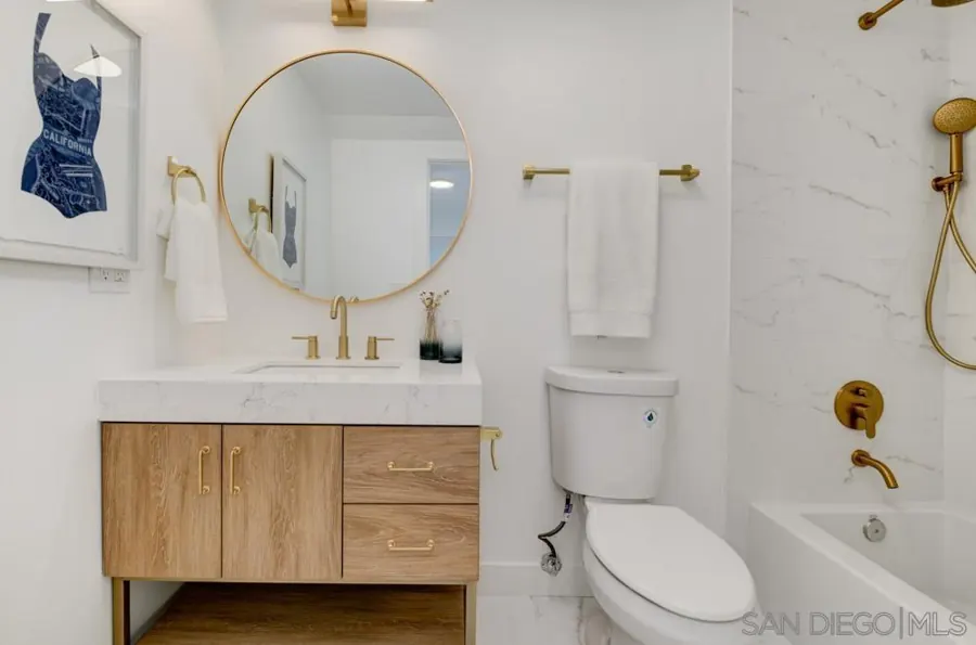 Bathroom with oak vanity and round mirror