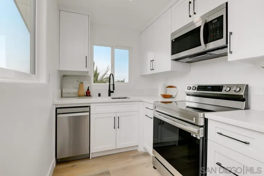 ADU kitchen with white cabinets