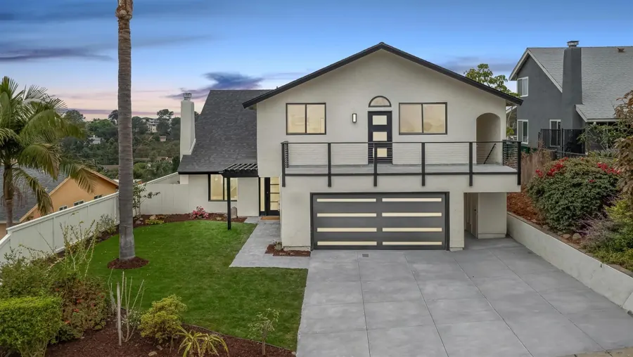 Front exterior with new garage door and balcony