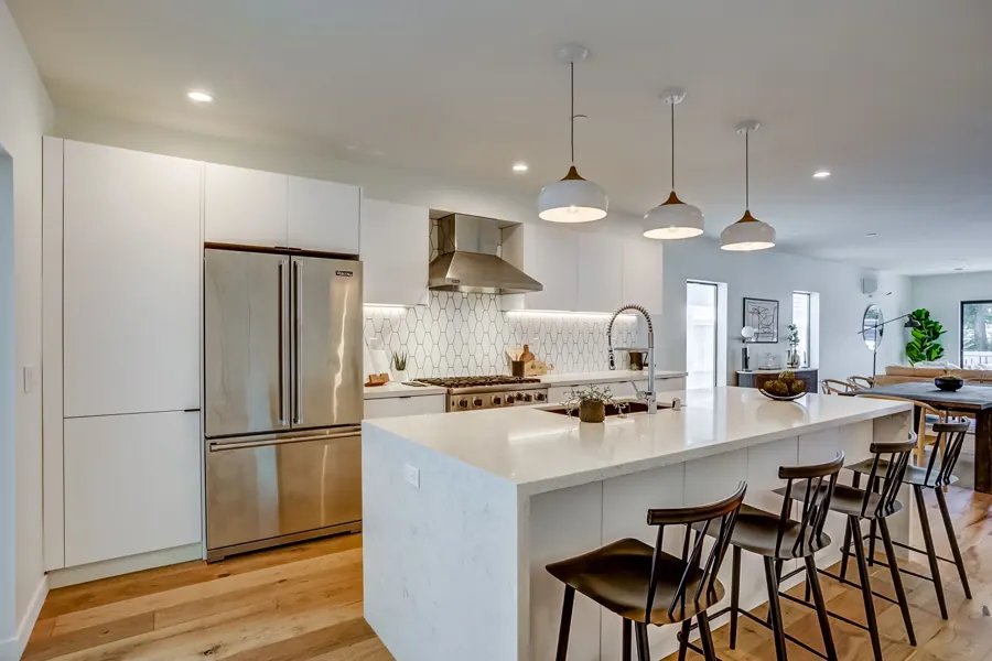 White kitchen with waterfall island and bar stools