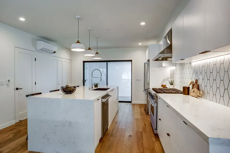 White kitchen island and range wall