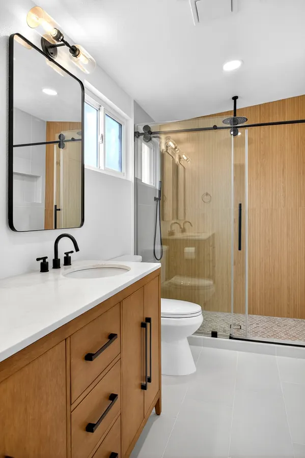 Bathroom with oak vanity and glass walk-in shower