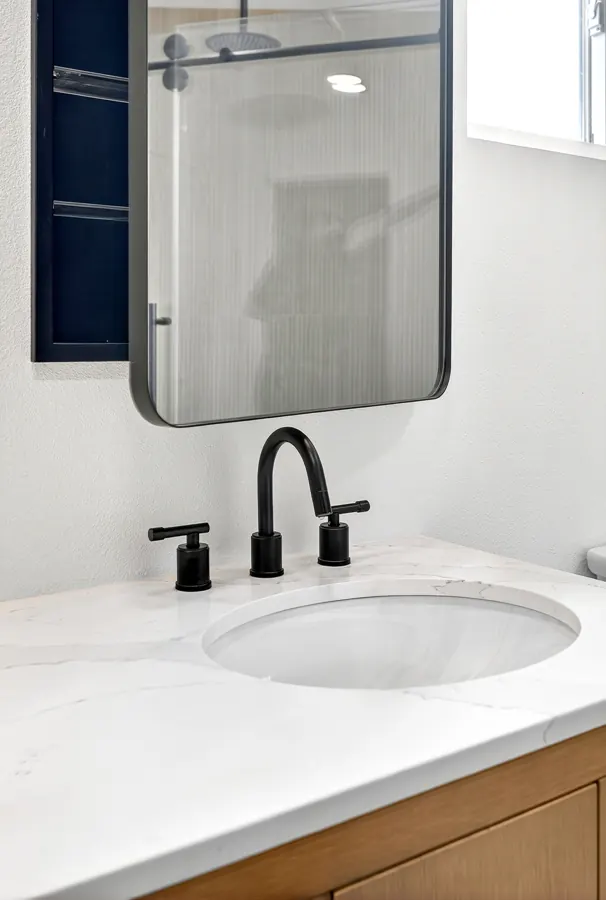 Vanity sink with black faucet and quartz top