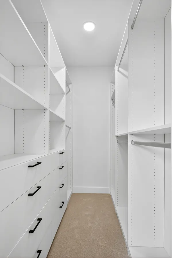 Walk-in closet with built-in shelving and drawers