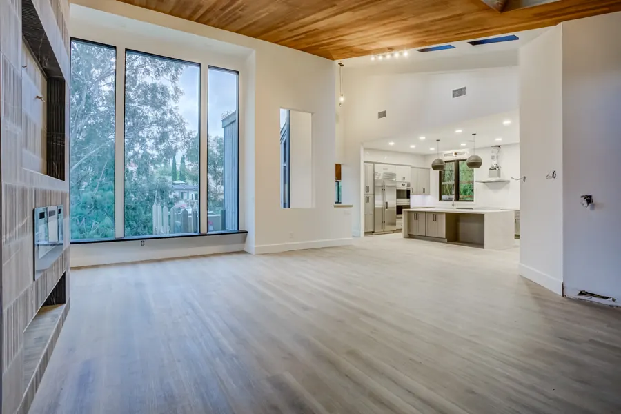 Great room with tall windows looking toward the kitchen
