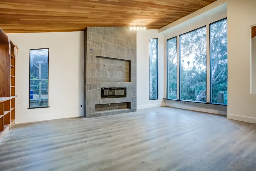 Living room with tiled fireplace wall and wood ceiling