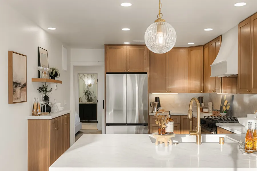 Kitchen with oak cabinets and built-in bar shelf