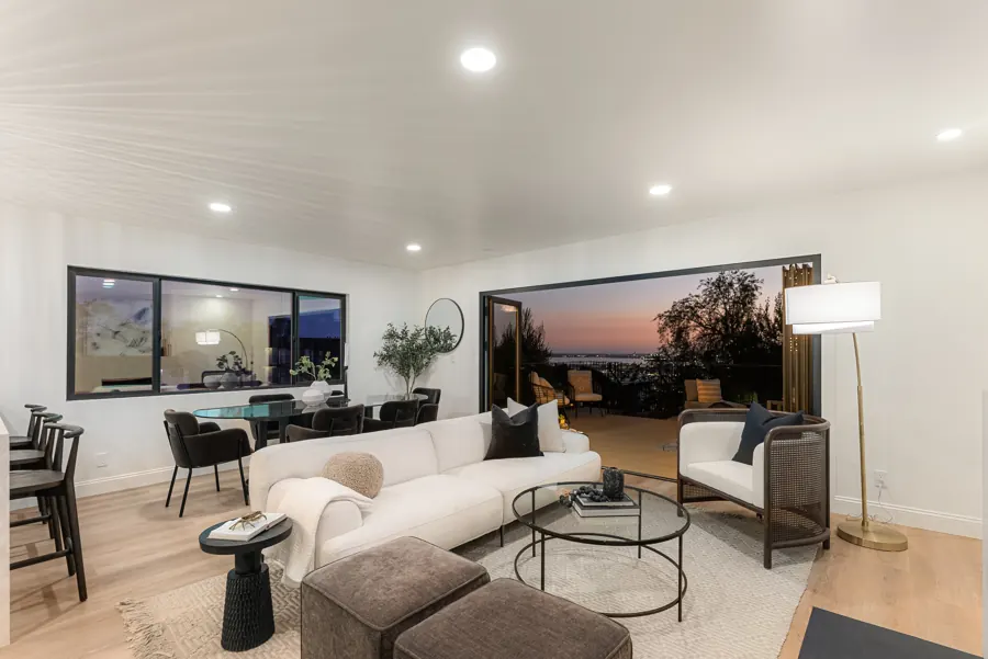 Living and dining room at sunset with bay view