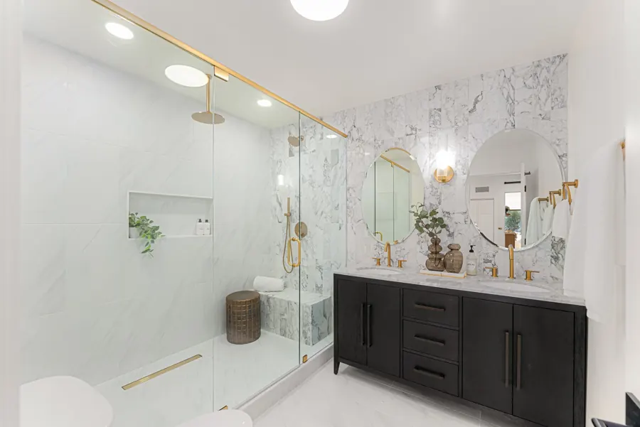 Bathroom with glass walk-in shower and black double vanity