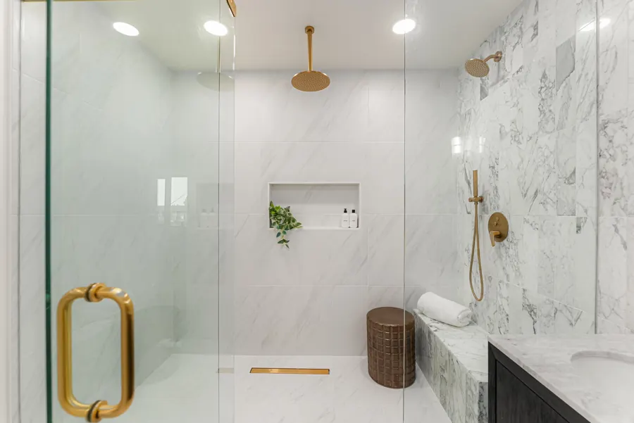 Marble walk-in shower with brass fixtures