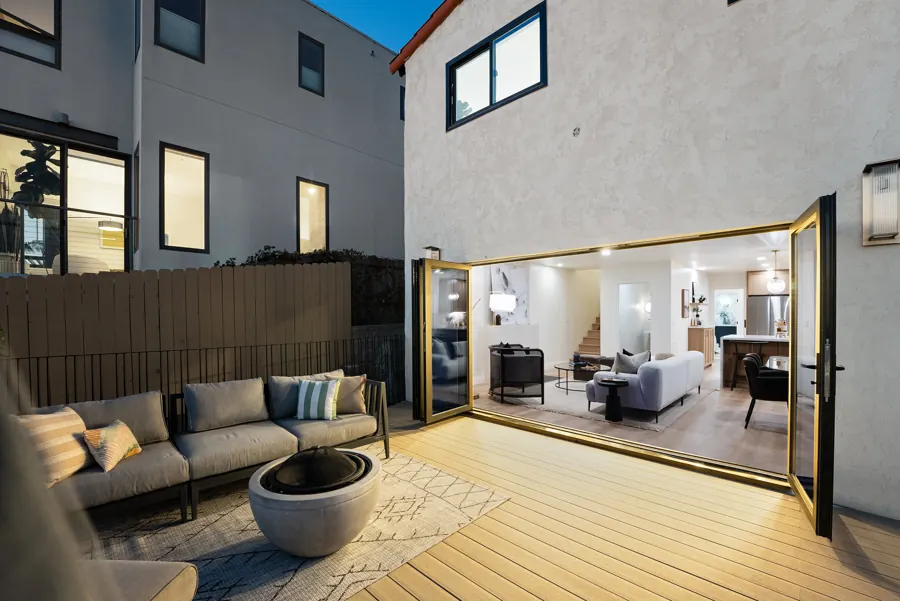 Rear deck at dusk with the living room lit