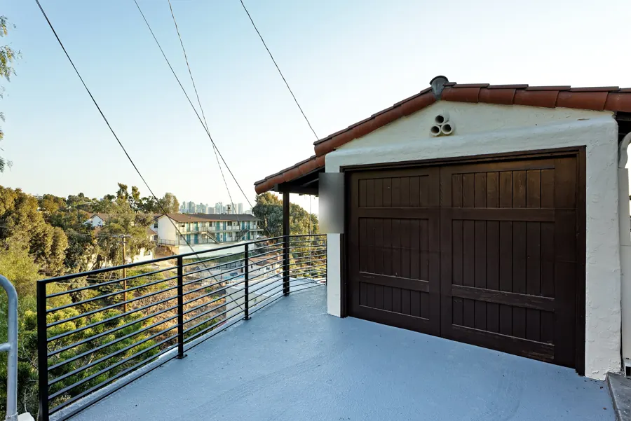 Garage with wood door and tile roof