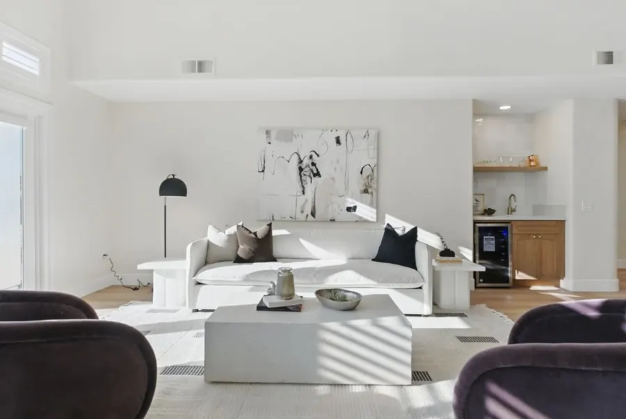 Living room sofa with wet bar beyond