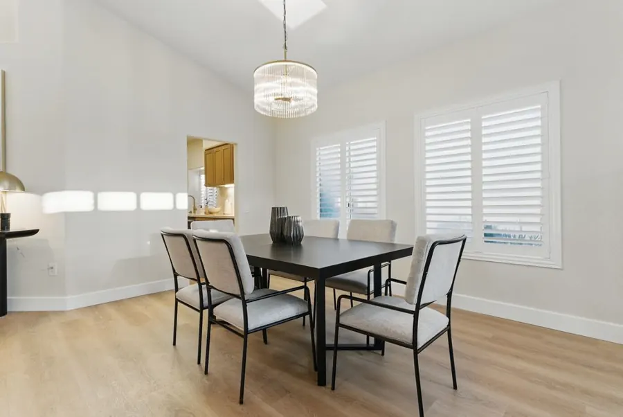 Dining room with crystal chandelier and plantation shutters