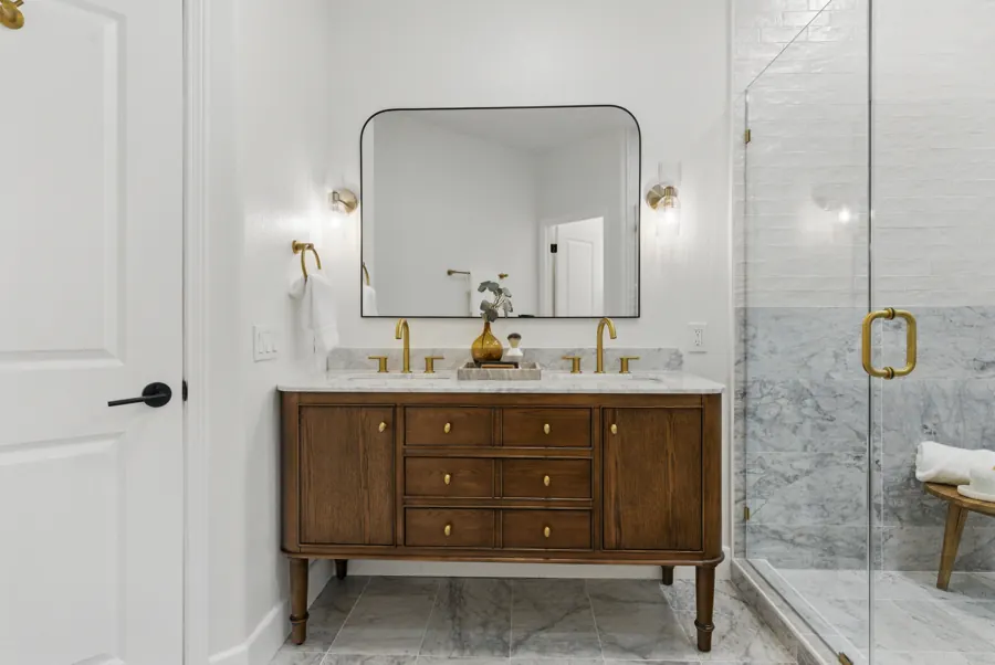 Walnut double vanity with brass fixtures