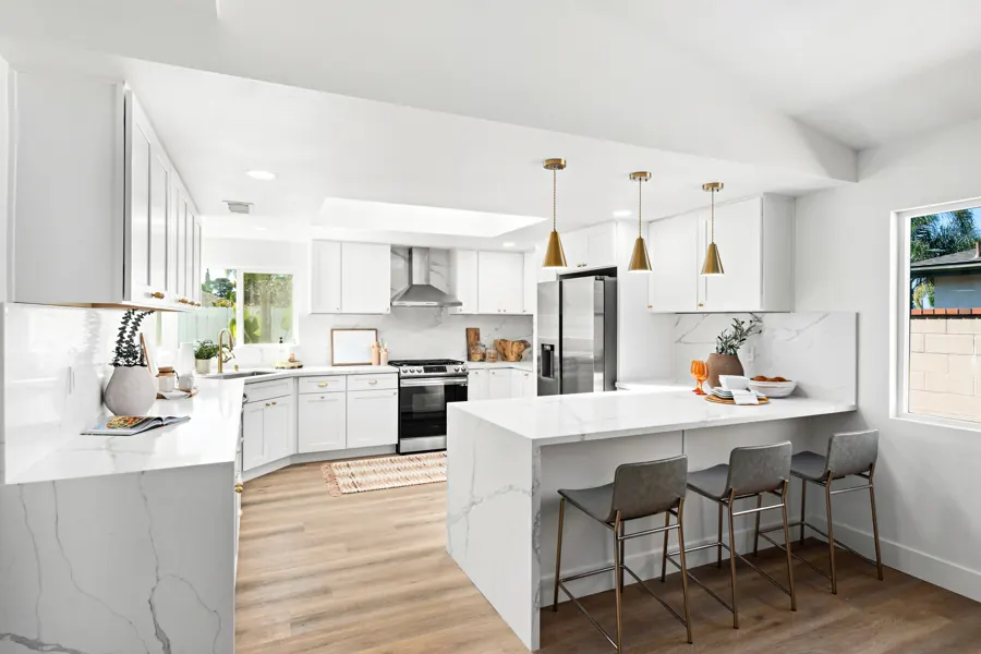 Kitchen with quartz waterfall peninsula and bar stools