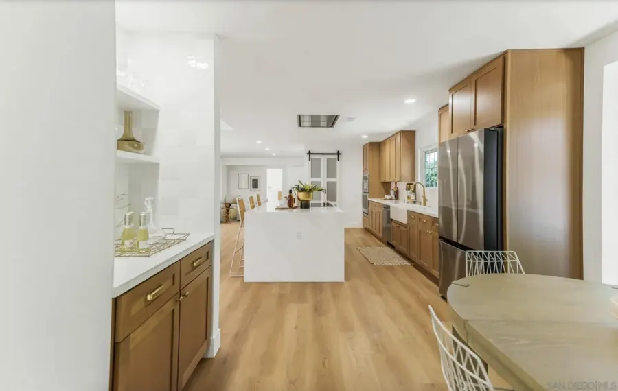 Kitchen viewed from the breakfast nook with built-in bar shelves