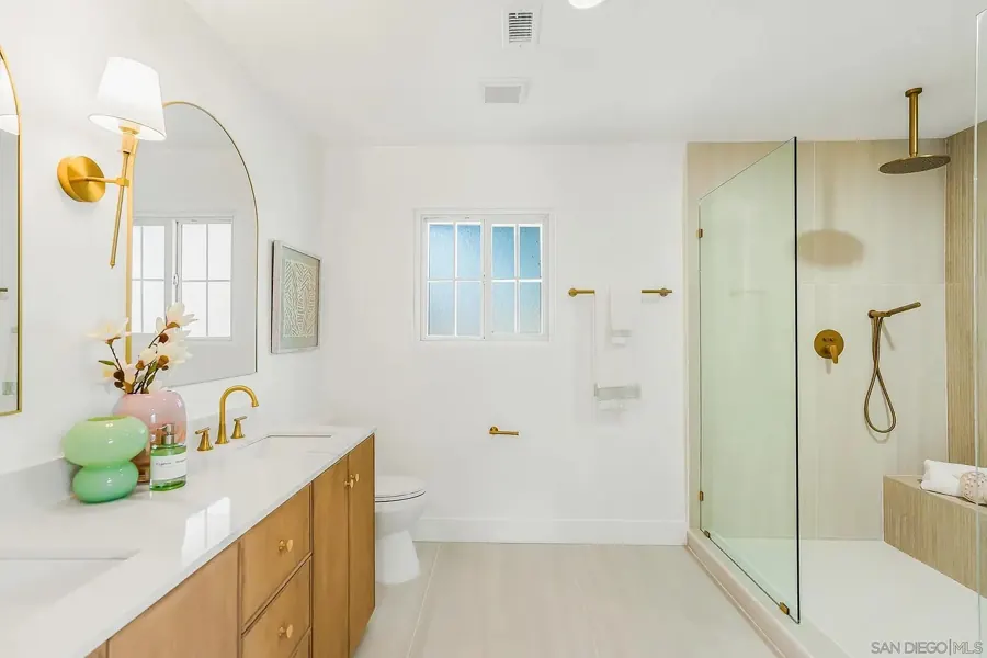 Primary bathroom with oak double vanity and walk-in shower