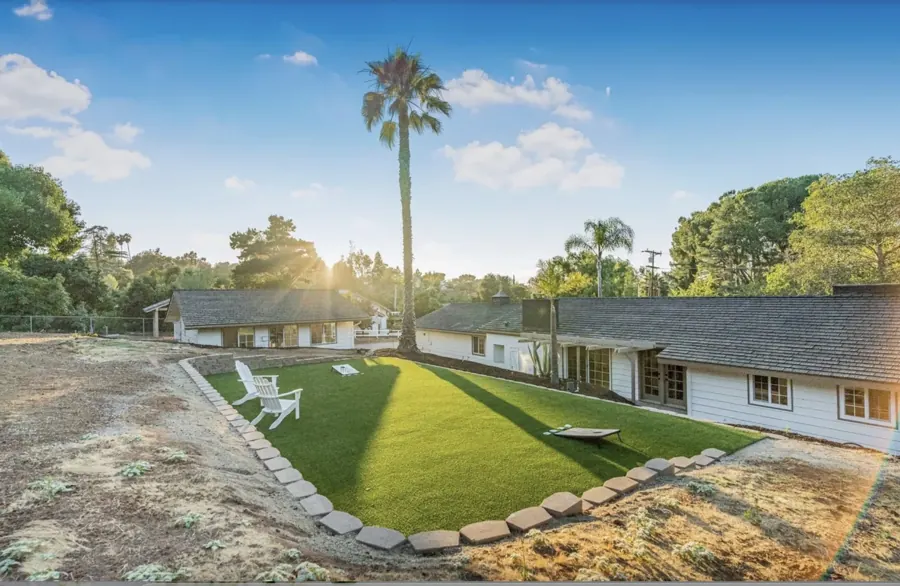 Backyard with lawn and view of the home