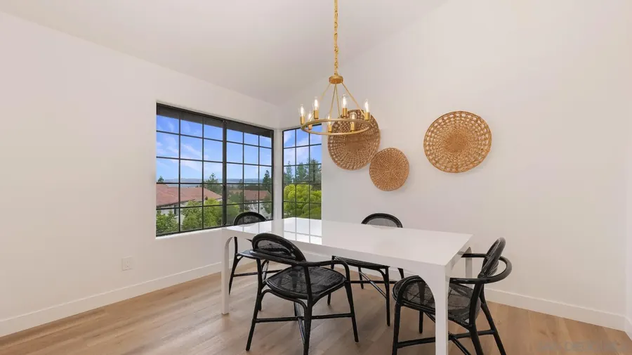 Dining area with brass chandelier and corner windows