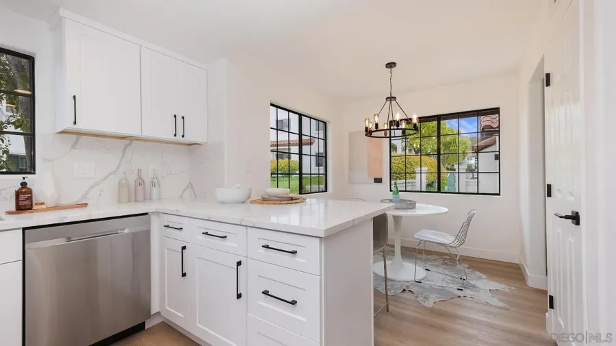 Kitchen peninsula with black hardware and breakfast nook